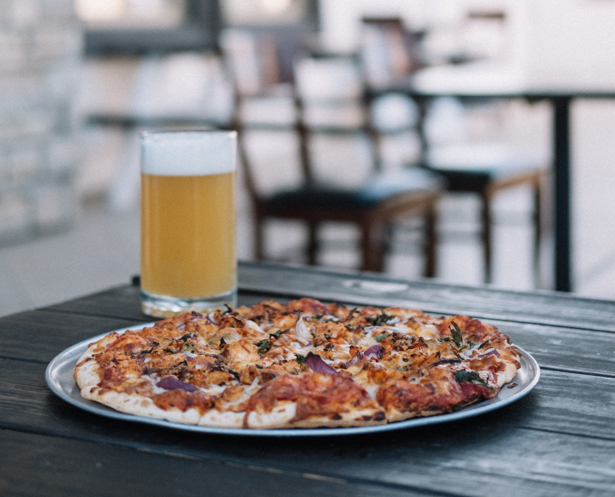 Two cold Blue Moon beers, a fully-loaded pizza and several delicious appetizers